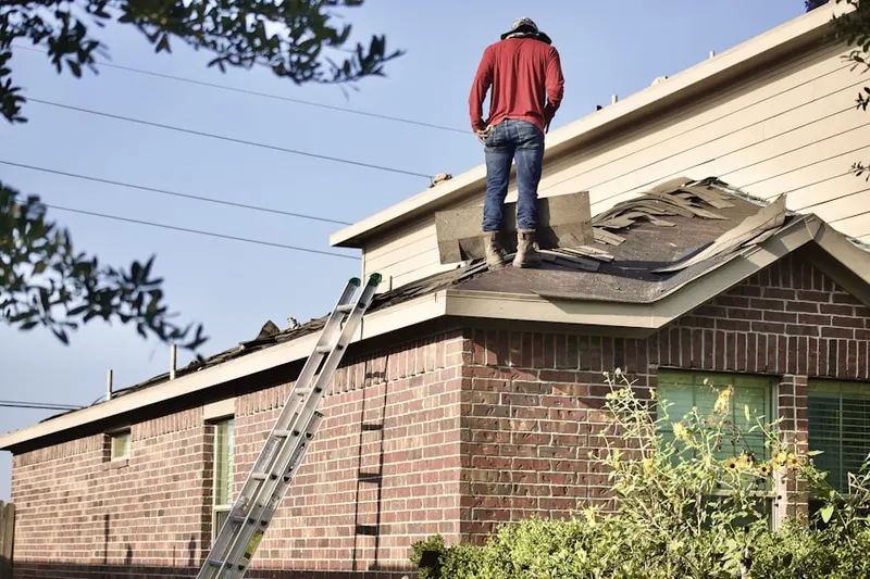 Professional roofer working on a residential roof in New Prague